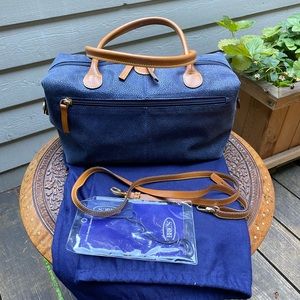 Bric’s mini duffel bag for carrying it on your wrist, shoulder  or cross-body.